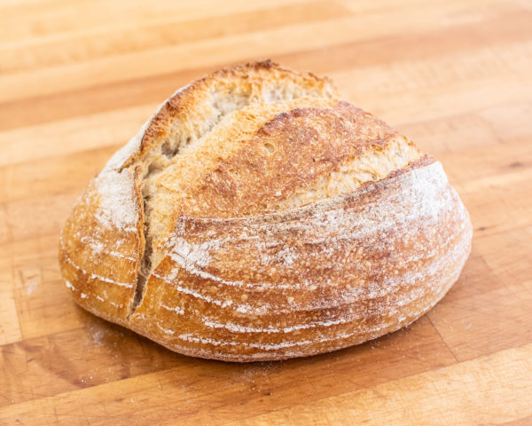 A Le Petit Paris sourdough loaf with a golden crust