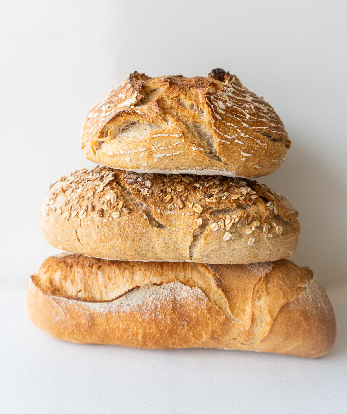 Three golden artisan loaves baked at Le Petit Paris