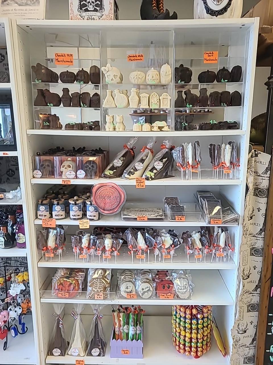 Halloween chocolate display at Le Petit Paris, with milk, white and dark selections, skulls, pumpkins and wrapped lollipops.